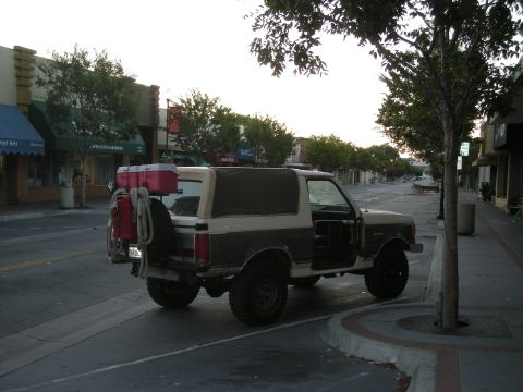 1991 Ford Bronco - This 1991 Ford Bronco is parked on the side of a street with its doors open.