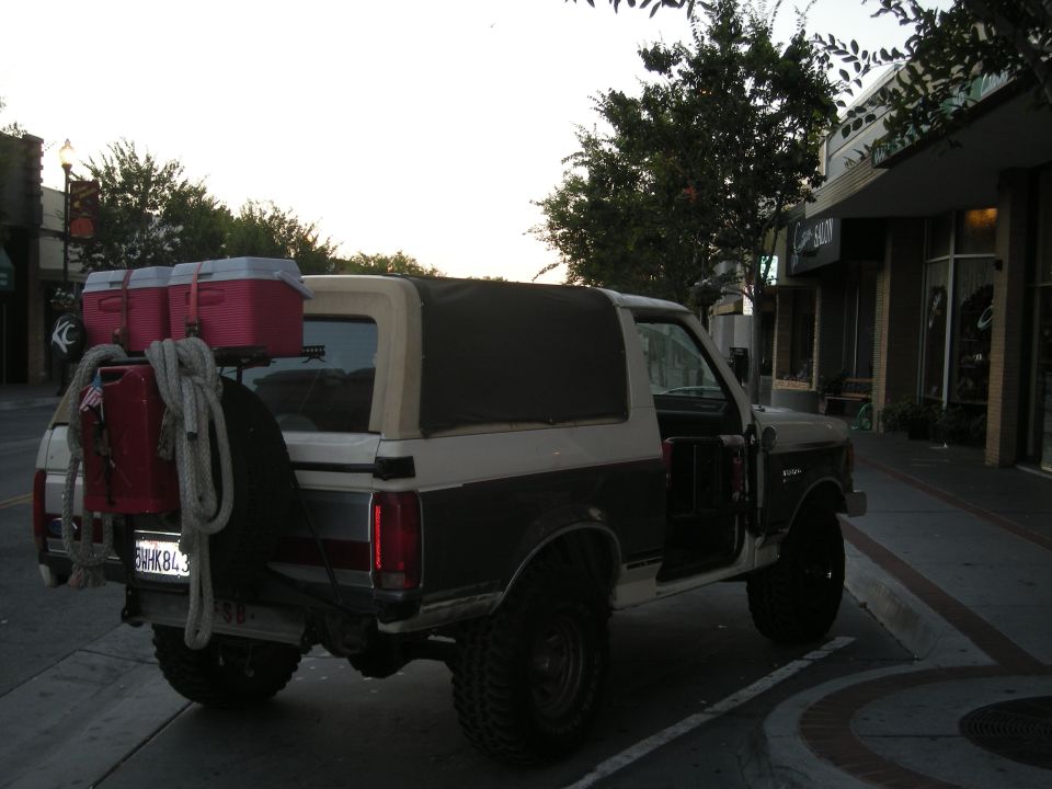 1991 Ford Bronco with coolers and rope on spare tire carrier