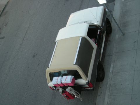 1991 Ford Bronco - Overhead view of a 1991 Ford Bronco parked curbside, showing its cargo and exterior.