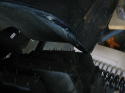 1995 Ford Bronco - A close-up view of a vehicle's tire and the underside of its fender liner.