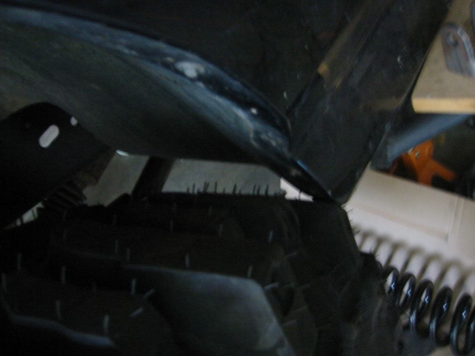 Close-up of a tire and fender liner, possibly from a truck or SUV