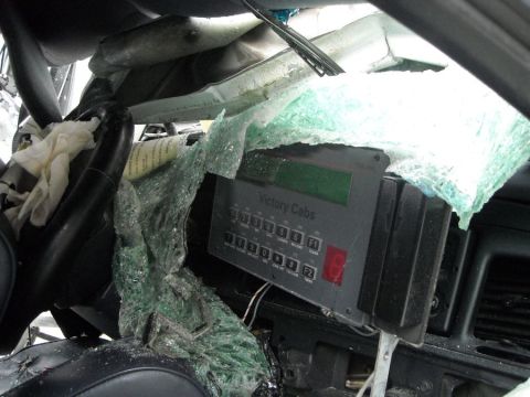 1996 Ford Crown Victoria - Interior view of a damaged taxi, a "Victory Cabs" meter and shattered windshield.