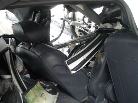 1996 Ford Crown Victoria - The interior of the vehicle shows extensive damage from a collision, with structural elements compromised.