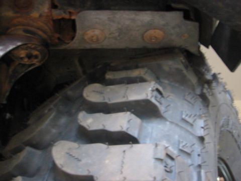 1995 Ford Bronco - Detail of a heavy-duty tire and suspension components, likely from an off-road vehicle.