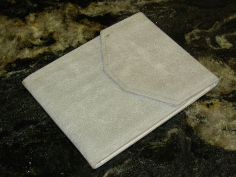 2004 Land Rover Land Rover - Owner's manual case, likely for a vehicle, shown on a granite countertop.