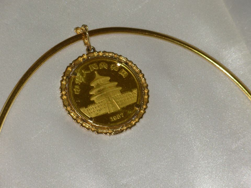 1987 Chinese Gold Panda coin in gold bezel pendant on a gold collar necklace