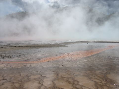 2006 Ford E350 - Steam rises from a colorful geothermal landscape with mineral deposits on the ground.