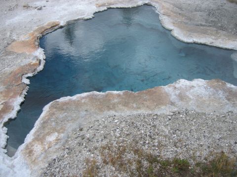 2006 Ford E350 - A natural hot spring with clear blue water and mineral formations.