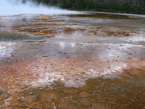 2006 Ford E350 - A wide view of a geothermal area with colorful mineral deposits and steam, indicating volcanic activity.