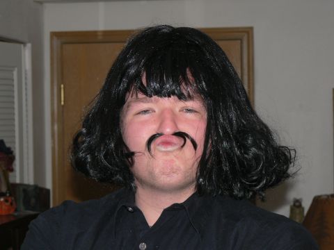 2006 Ford E350 - A person is dressed up in a wig and fake mustache, making a funny face.