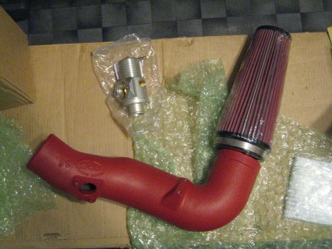 2007 Subaru Impreza - Red APS WRX-HFA/01 CAI intake system with a red air filter and a silver bypass valve, packaged for shipping.