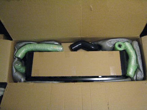 2007 Subaru Impreza - A new intercooler and piping kit is shown packed inside a cardboard box, ready for installation.
