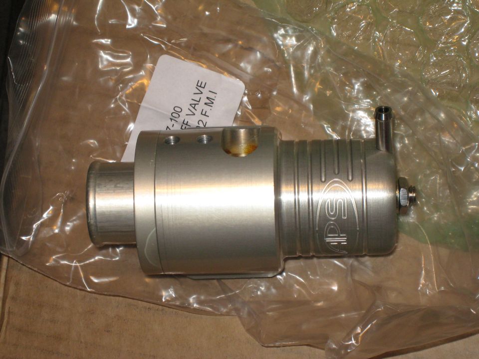 APS blow-off valve in plastic packaging. Label reads '7-100 BOV VALVE 2 F.M.I.'