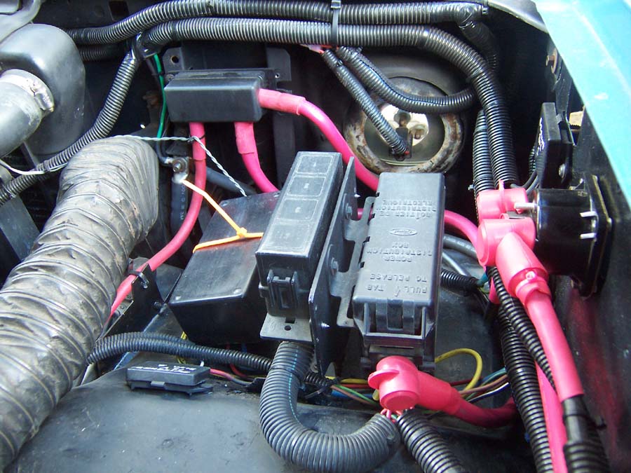 3G alternator connection on the radiator support member.  Left to right Switched 12V distribution block, Fan Control, Relay box, Fuse box, start solenoid, and ground distribution block