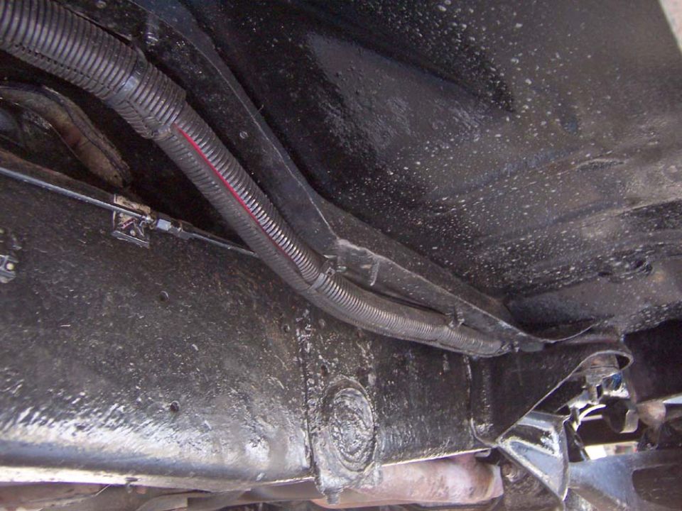 Ran two number 2 battery cables encased in a black plastic wire shroud.  Exiting the engine compartment.