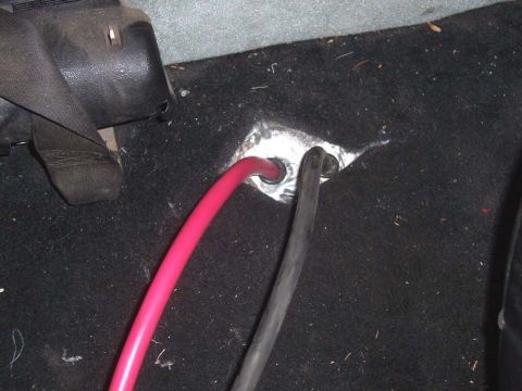 1983 Ford Bronco - Brought cables up through floor by drilling 2 half inch holes and using a rubber cable grommet to prevent damage to the cables.