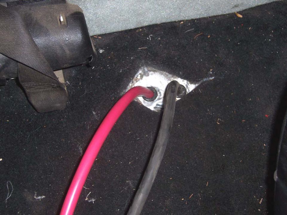 Brought cables up through floor by drilling 2 half inch holes and using a rubber cable grommet to prevent damage to the cables.