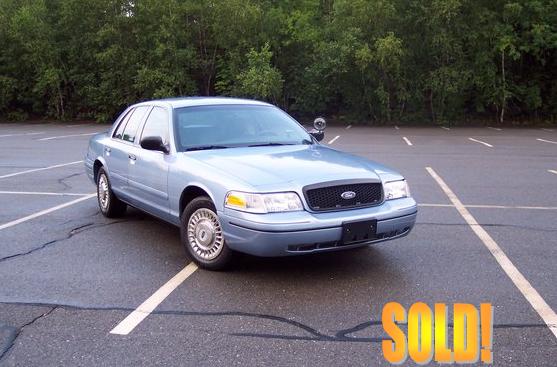 2001 Ford Crown Victoria parked in a lot, "SOLD!" graphic in lower right