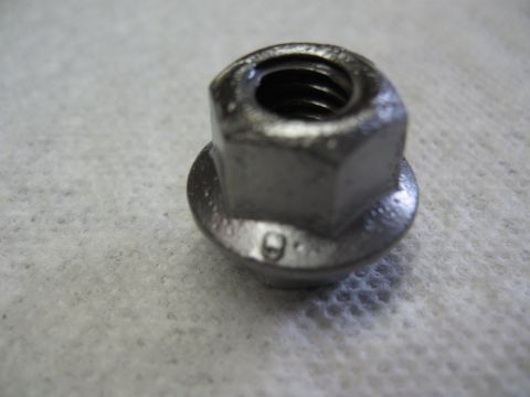 1968 Shelby GT500 - A single flanged nut, marked with a '9', rests on a textured surface.