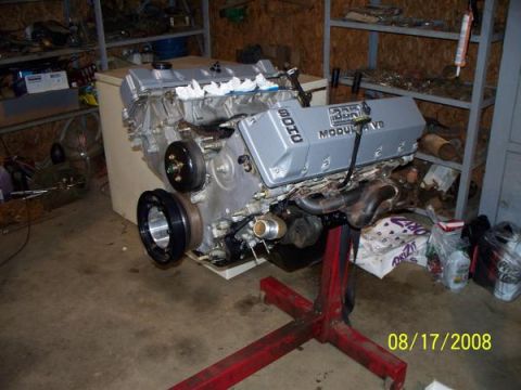 2007 Ford Mustang - Engine on a stand in a garage setting. The engine has '32V MODULAR V8' visible on its cover.