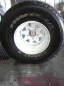 1987 Ford Bronco - Close-up of a Goodyear Wrangler tire on a white steel wheel.
