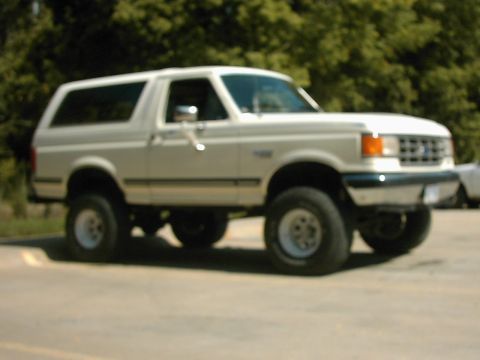 1987 Ford Bronco - This 1987 Ford Bronco is shown from a three-quarter front view, highlighting its grille and body style.