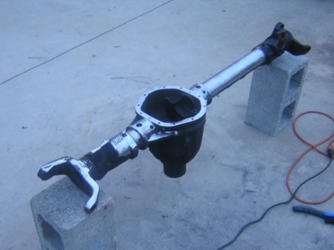 1993 Ford Bronco - Ford Bronco rear axle assembly, likely from a 1993 model, resting on cinder blocks.