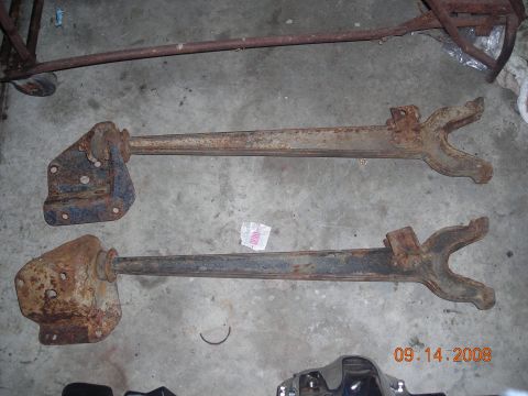1993 Ford Bronco - These are old, rusty suspension components, likely for a truck or SUV, shown on a concrete surface.