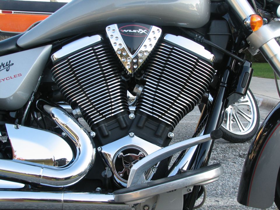 Victory motorcycle engine with V-twin cylinders and chrome exhaust pipes