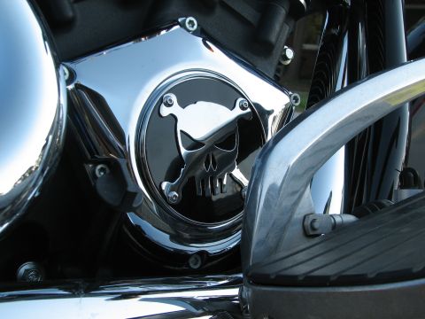 2006 Victory Kingpin - This motorcycle part features a prominent skull and crossbones design on its chrome cover.