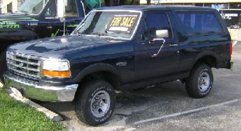 1993 Ford Bronco - This 1993 Ford Bronco is seen parked next to another vehicle, with a "FOR SALE" sign displayed in the windshield.