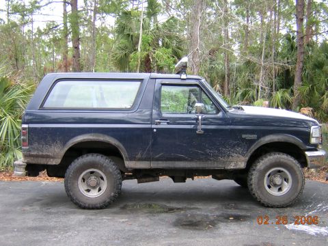 1993 Ford Bronco - Side view of a 1993 Ford Bronco, showing its body style and tires.