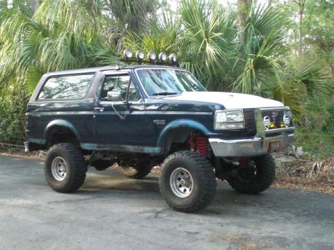 1993 Ford Bronco - This modified Ford Bronco features a lifted suspension and multiple auxiliary lights mounted on the roof.