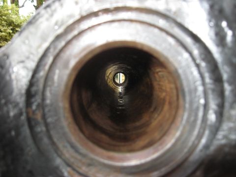 1991 Ford Bronco - A close-up view looking down the length of a metal pipe towards a distant opening.