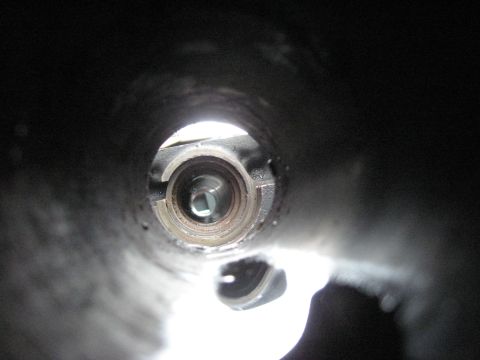 1991 Ford Bronco - Close-up view into a metal tube with a square opening, possibly part of a mechanism.