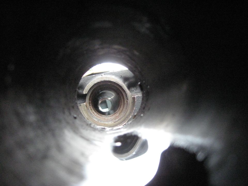 view into a metal tube showing a square opening and internal mechanism