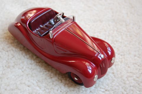 1968 Chrysler Town & Country - This red toy car features a classic rounded body style and a prominent front grille.