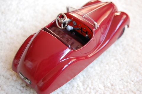 1968 Chrysler Town & Country - Close-up view of a red toy car's interior, a steering wheel and dashboard. A badge on the side reads 'EXUCO'.