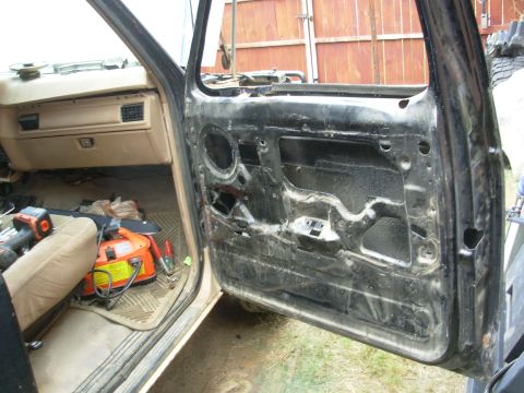1983 Ford Bronco - The door has been emptied, and the wiring is loose inside it. It's ready to come off. This is an '80-81 door that I modified to use a '92-9…