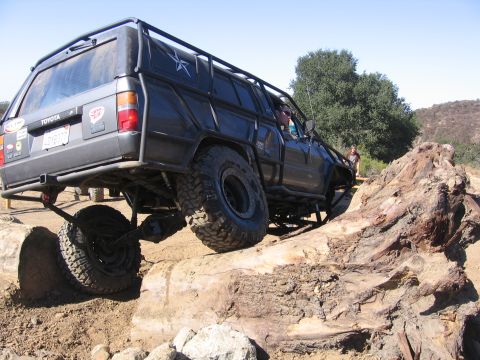1989 Ford Bronco - This heavily modified Toyota 4Runner is tackling a challenging off-road obstacle.