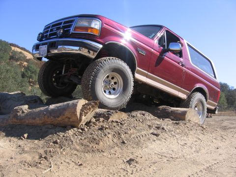 1989 Ford Bronco - This Ford Bronco is navigating an obstacle course with large logs.