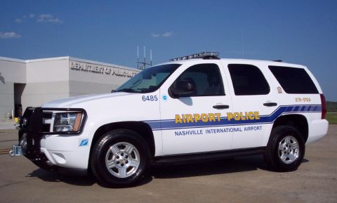 1991 Ford Crown Victoria - A white police SUV is parked in front of the Department of Public Safety building at Nashville International Airport.