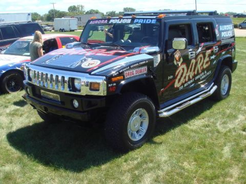 1991 Ford Crown Victoria - This Hummer H2 is decorated with DARE and Aurora Police branding, suggesting a community outreach or law enforcement vehicle.