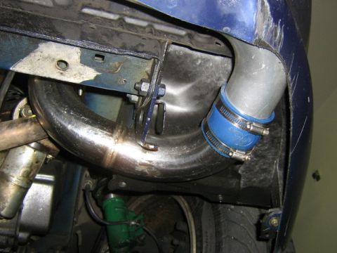 1995 Ford Probe - Custom exhaust piping is installed on a vehicle, showing the connection points and clamps.