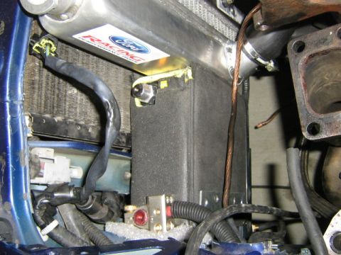 1995 Ford Probe - Detail shot of engine bay components, including a Ford Racing sticker on the radiator and various wires and hoses.