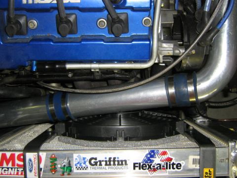 1995 Ford Probe - Close-up of engine bay components, including turbo piping and a blue valve cover.