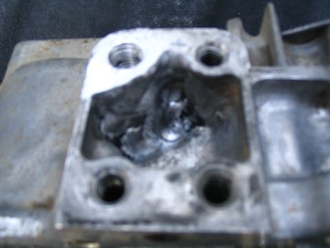 1987 Suzuki Samurai - Close-up view of a damaged transfer case housing, showing significant internal wear and debris.