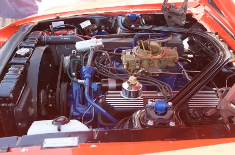 1968 Shelby GT500 - Close-up of a V8 engine bay, likely from a 1968 Ford Mustang, showing the carburetor and radiator.