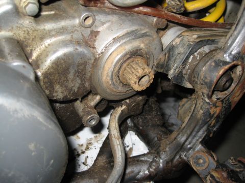 1993 Suzuki RMX250 - A close-up view of a dirty, splined shaft on a motorcycle engine component.