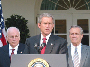 1971 Ford Ranchero - George W. Bush addresses the public from a podium, with Dick Cheney and another man present.